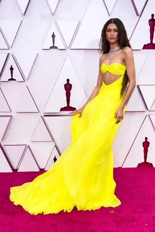 Zendaya shines in a bright yellow custom gown by Valentino. - (Photo by Chris Pizzello-Pool/Getty Images)
