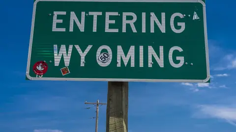 Welcome to Wyoming State Highway sign welcomes drivers. (Photo by: Visions of America/Joe Sohm/Universal Images Group via Getty Images)