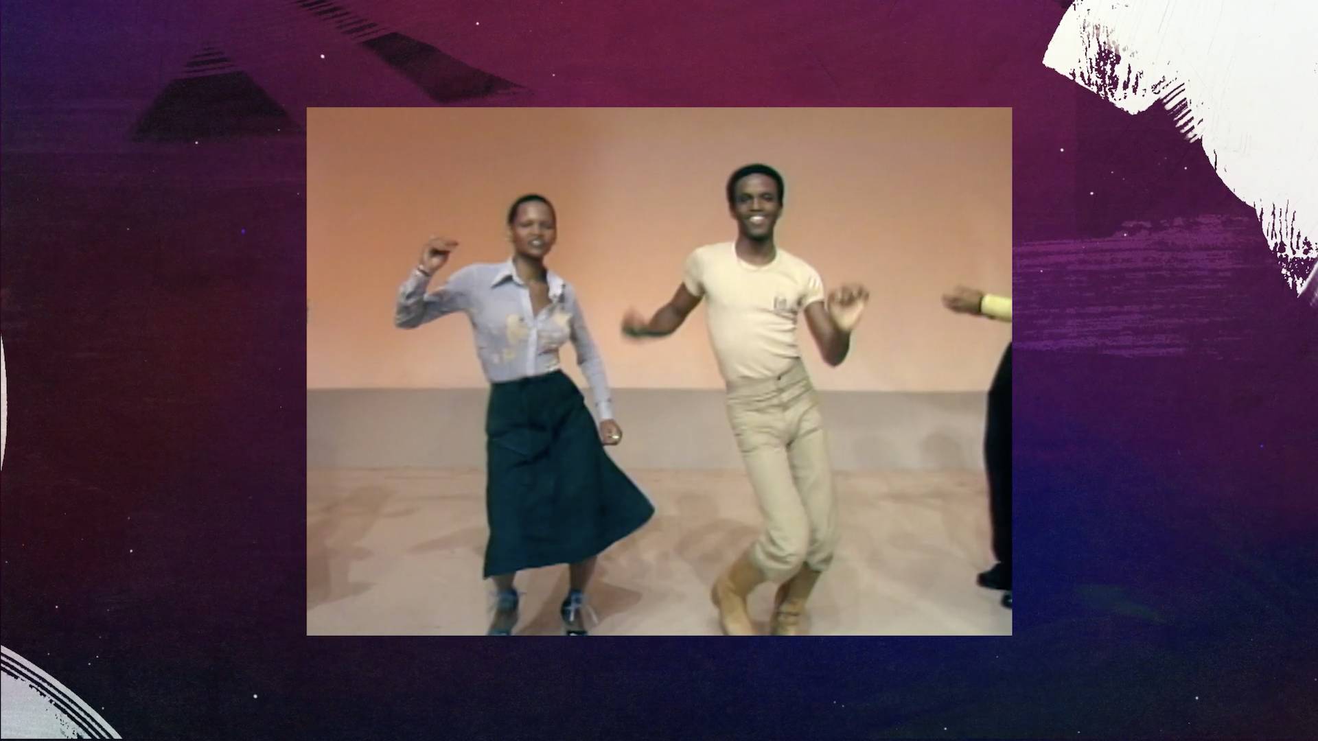 A woman in a blue shirt and blue skirt and a man in a yellow shirt and tan pants, dancing in The Soul Train line in the 1970s.