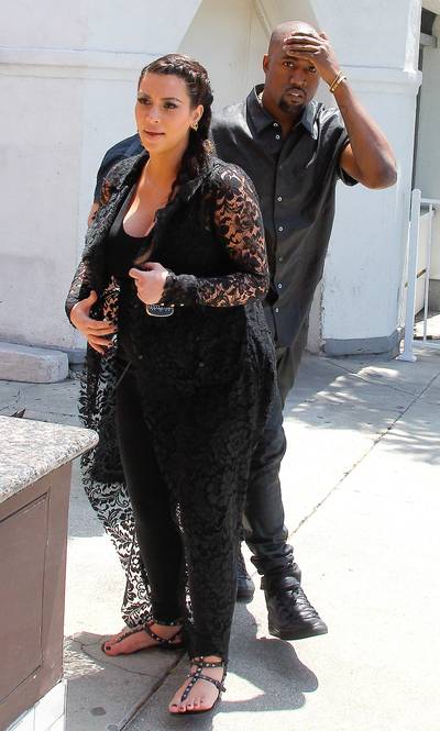 Oops... - Kanye wins some and loses some and on Friday while the paparazzi was snapping pics of him and Kim, he walked into a walkway sign. Hopefully the headache he had after that wasn't too bad. (Photo: Splash News)