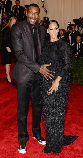 Alexis Stoudemire - New York Knicks All-Star forward Amar’e Stoudemire and his wife Alexis clearly consulted one another before deciding on this monochromatic palette for the 2013 Met Gala. From the gown’s lush feathers to Amar’e’s casual kicks, it’s the small details that make this couple look pop.&nbsp;   (Photo: Dimitrios Kambouris/Getty Images)