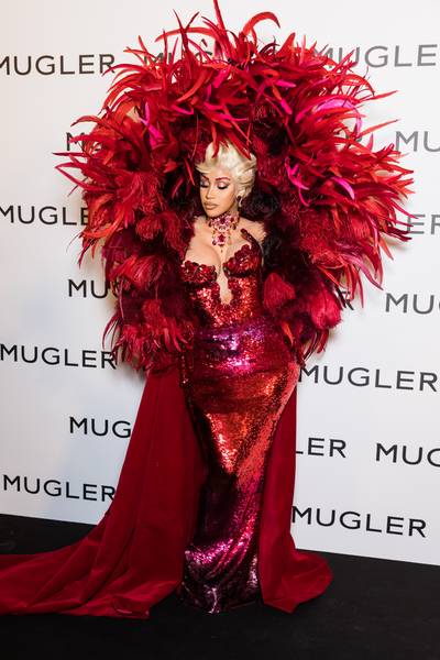 Paris Fashion Week-&nbsp;Thierry Mugler Fashion Exhibit - On Wednesday (Sept. 28),&nbsp;Cardi B&nbsp;dropped jaws when she made her grand debut during Paris Fashion Week! While attending the Thierry Mugler fashion exhibit, the “Up” rapper stunned in a lovely red sequin gown, featuring a magnificent feathery cape.&nbsp;For those who may not know, this marks the mother-of-two’s first public appearance since&nbsp;giving birth&nbsp;to her son earlier this month. (Photo by Richard Bord/WireImage) (Photo by Richard Bord/WireImage)
