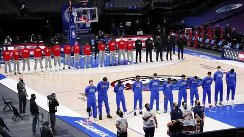 DALLAS, TEXAS - FEBRUARY 10: The Dallas Mavericks and the Atlanta Hawks stand for the National Anthem prior to tipoff of their NBA game at American Airlines Center on February 10, 2021 in Dallas, Texas. NOTE TO USER: User expressly acknowledges and agrees that, by downloading and or using this photograph, User is consenting to the terms and conditions of the Getty Images License Agreement. (Photo by Tom Pennington/Getty Images)