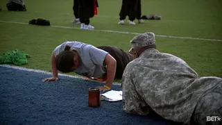 Testing Their Strength - A cadet does push-ups while an officer provides motivational support.   (Photo: BET)