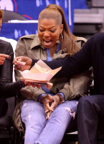 Just Say No! - Queen Latifah cringes at some game time goodies as her fans pass them in front of her at the Los Angeles Clippers versus the Houston Rockets game at Staples Center in downtown Los Angeles.&nbsp;(Photo: London Entertainment / Splash News)