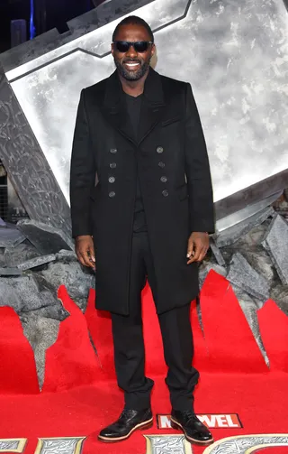 Idris Elba - A dapper Elba opts for all-black everything at the London&nbsp;Thor: The Dark World premiere. Brits love a good trench and the double-breasted style Idris is wearing earns our stamp of approval for fall.&nbsp;  (Photo: Lia Toby/WENN.com)