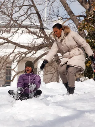 Snow Days - One of the perks of living at the White House is the grounds and the South Lawn proved to be a perfect place to sled during Malia's first winter there.  (Photo: WENN)