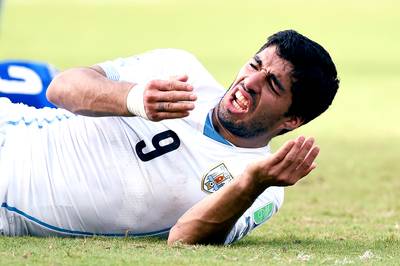 Luis Suarez Banned Four Months For Biting - FIFA has come down hard on Uruguay striker Luis Suarez for biting Italy defender Giorgio Chiellini during a World Cup match on Tuesday. On Thursday, FIFA announced that Suarez will be suspended for nine matches and banned for four months from all soccer-related activity, as reported by the Los Angeles Times. That means Suarez will not be available for Uruguay's second-round match with Colombia on Saturday. This was the third time Suarez bit an opponent during a match dating back to his first infraction in 2010.&nbsp;(Photo: Matthias Hangst/Getty Images)