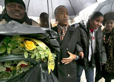 Rev. Al Sharpton Delivers Wreath to Garner's Memorial - In memory of Eric Garner, Rev. Al Sharpton walked with the slain father's widow, Esaw Garner, to the scene of his death to place a wreath at the site Saturday (Dec. 6).&nbsp;(Photo: AP Photo/Richard Drew)