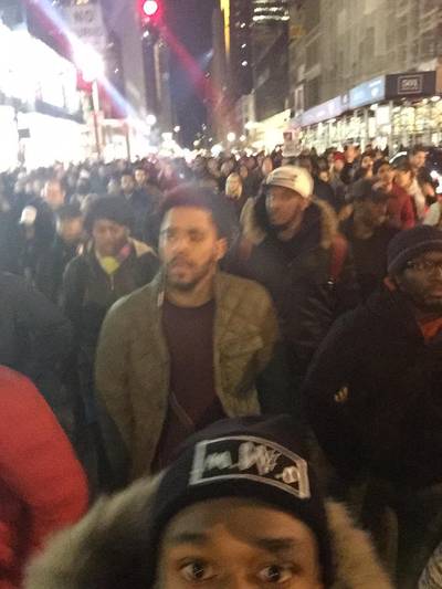 J. Cole - Further infuriated by the decision of the grand jury not to indict the officer,&nbsp;J. Cole&nbsp;was among the people marching in New York to protest in December 2014.(Photo: QuikWest via Twitter)
