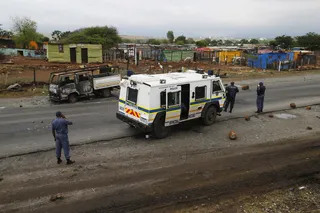South Africa Arrests Gold Miners - Police used rubber bullets and stun grenades to break up a sit-in by protesters at a police station over the weekend. More than 70 miners from a nearby Gold Fields mine were also arrested in the operation.  (Photo: REUTERS/Mike Hutchings)