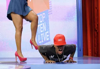 Extra Weight For The Win - Bow Wow joins the push up battle with some support (or is in hindrance?) from Paigion at 106 &amp; Park, October 11, 2012. (Photo: John Ricard / BET)