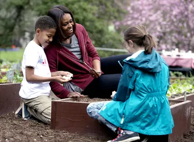 Let's Get This Planting Started! - The first lady plants seeds with Nare Kande, 9, an avid gardener in the New York Botanical Garden's children's gardening program, and Marley Santos, 11, of Foothill Elementary School in Boulder, Colorado.(Photo: Carolyn Kaster/AP Photo)