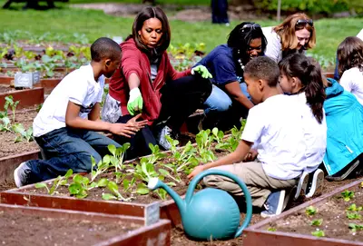 Digging In - The first lady offers some guidance on planting.(Photo: Kevin Dietsch/UPI/Landov)