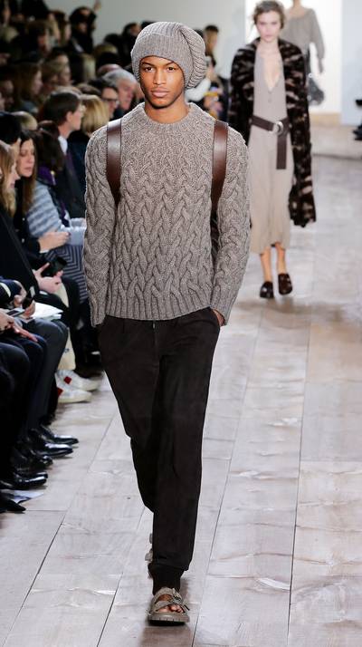 Michael Kors - Teaming a classic cable knit sweater and crisp, black slacks, Kors captures easy elegance and sophistication.  (Photo: Neilson Barnard/Getty Images for Michael Kors)