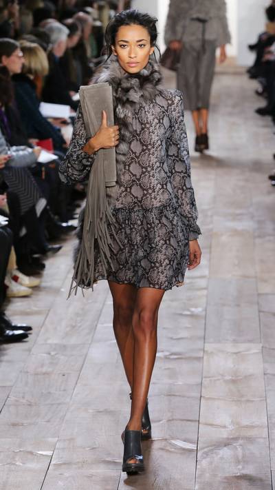 Michael Kors - This look screams exotic luxury, pairing a sheer, python print frock with a sumptuous fur stole. And we need that fringed envelope clutch in our life, too. (Photo: Neilson Barnard/Getty Images for Michael Kors)