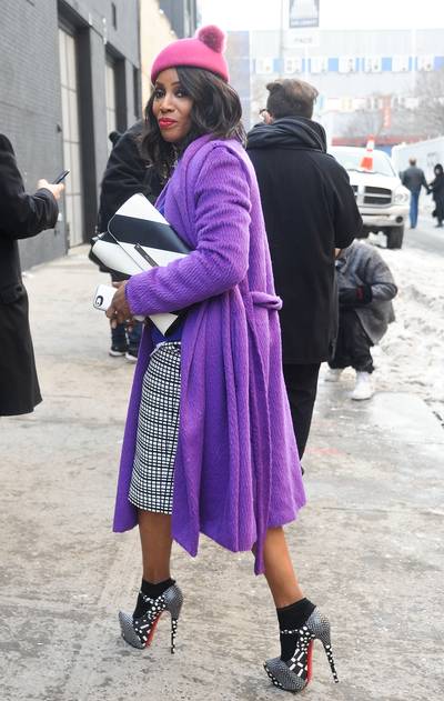 June Ambrose - First Beyoncé, now June Ambrose is hitting us with Eugenia Kim’s adorable knit pom-pom beanie. The celebrity stylist keeps the fashion parade going in her amethyst-hued Alberta Ferretti coat, Marc Jacobs skirt and polka-dot and python print Christian Louboutin Mary Janes. &nbsp;  (Photo: Daniel Zuchnik/Getty Images)