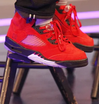 Fire Man - Stalley rocks some fire engine red 23's on 106.&nbsp; (Photo: Bennett Raglin/BET/Getty Images for BET)