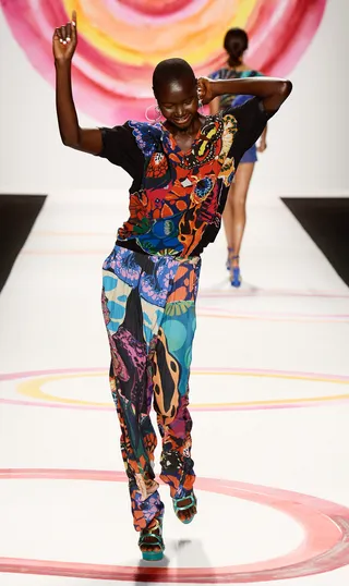Desigual Spring 2014 - It’s a fashion party! Desigual does not disappoint with its staple mix of bold patterns and relaxed shapes. We've already added this jumpsuit to our wish list!  (Photo: Frazer Harrison/Getty Images)