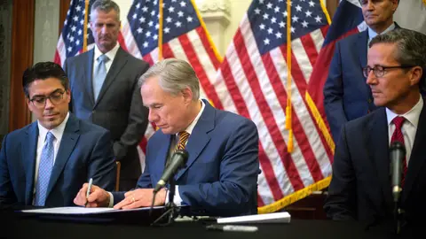 AUSTIN, TX - JUNE 08: Texas Governor Greg Abbott signs Senate bills 2 and 3 into law during a press conference at the Texas State Capitol in Austin on June 8, 2021. The bills require electricity providers operating on the grid managed by ERCOT to weatherize equipment, creates a state-wide power outage alert system and regulates ERCOTâs board of directors. The bill signing comes months after a disastrous February winter storm that created widespread power outages and left dozens of Texans dead. (Photo by Montinique Monroe/Getty Images)