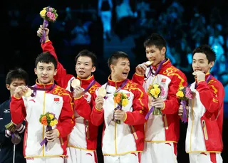 China's Men Flip Into the Spotlight - China's male gymnastic team celebrate their win in the Artistic Gymnastics Men's Team final. (Photo: Ronald Martinez/Getty Images)