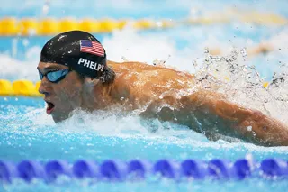 Breathe It Out - Michael Phelps of the U.S. team comes up for a breath while competing in the men's 200m butterfly competition. (Photo: Clive Rose/Getty Images)