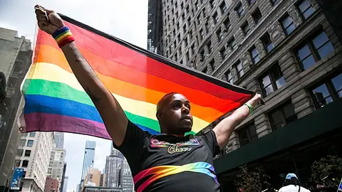 NEW YORK, NEW YORK - JUNE 27: A man with a flag walks during the Queer Liberation March parade on June 27, 2021 in New York City. Many participants walk around town to celebrate New York City Pride. The Queer Liberation March is an alternative Pride celebration free of police officers and major corporate sponsors. (Photo by Pablo Monsalve / VIEWpress via Getty Images)