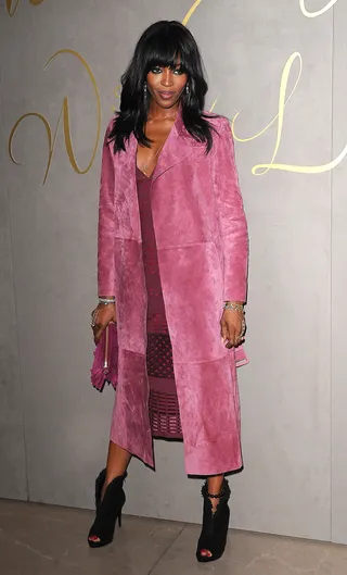 #Flawless - Just call her Naomi the Fashion Slayer! Supermodel Ms. Campbell gives us effortless chic in a suede raspberry trench and matching sheath at the the premiere of the Burberry Festive Film in London.  (Photo: Splash News)