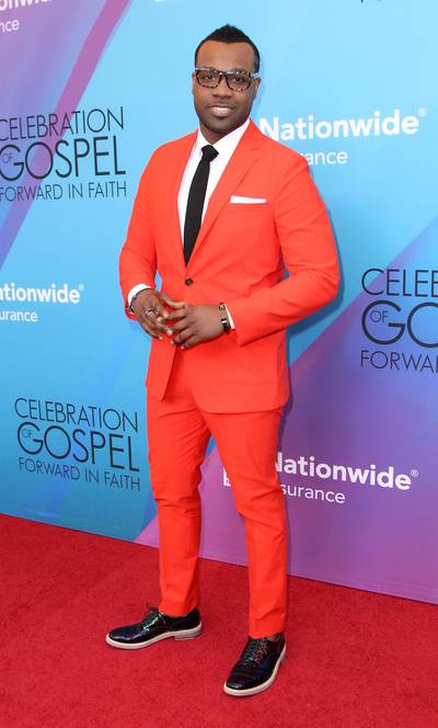 Red for the Win - Instead of going with a traditional suit color like black or gray, VaShawn Mitchell switched it up and rocked a blood orange suit and balanced the color with a white collared shirt, simple black tie and black shoes.  (Photo: Maury Phillips/BET/Getty Images for BET)