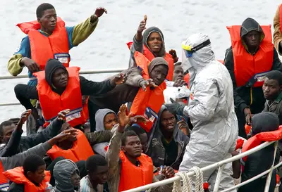 Malta Army Rescues 86 Migrants - Dozens of sub-Saharan African migrants were recently rescued by the Maltese army during a deadly crossing to the Southern European island country, the AP reports. The army was able to rescue 87 passengers aboad a drifting dinghy, but as many as 20 migrants are feared dead. The survivors — all men — hail from Mali, Burkina Faso, Guinea and Ivory Coast.(Photo: Darrin Zammit Lupi/Landov)