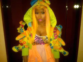 Put Your Hood Up\r - “Japan. Outfit/Wig #4” consisted of a funky hooded multicolored jacket with stuffed animal bears on the sleeve. Nicki kept it wild with an animal-print top and orange and pink skirt with a matching orange-blonde wig.\r\r(Photo: Courtesy Twitter)