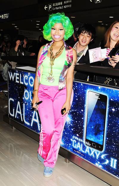 Japanese Barbiez - Nicki Minaj signs autographs and greets fans as she arrives in a neon green wig and hot pink track pants at Narita International Airport in Narita, Japan. (Photo: Jun Sato/WireImage)