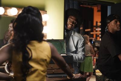 Sinqua Walls peeks at Kelly Rowland on the &quot;American Soul&quot; set. - (Photo: Jace Downs/BET)