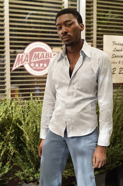 Tyrin Niles is in character as Jamie &quot;Latch&quot; Collins outside Ma Mable's Café. - (Photo: Jace Downs/BET)
