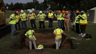 TULSA, OKLAHOMA - July 13:  Archaeologists and researchers examine a hole that was dug during a test excavation of the possible 1921 Tulsa Race Massacre Graves at Oaklawn Cemetery in Tulsa, Oklahoma on July 13, 2020. (Photo by Nick Oxford for The Washington Post)