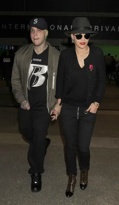 Travel Mates - Rita Ora and her boyfriend, Ricky Hilfiger, son of fashion designer Tommy Hilfiger, are all smiles upon their arrival in Los Angeles at LAX airport.(Photo: Sharky/Splash News)