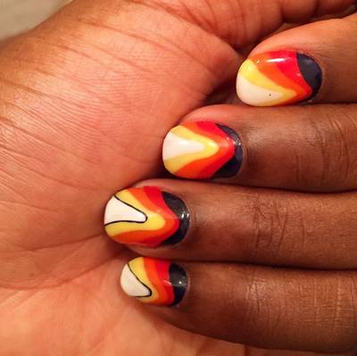 Estelle - “That 70's show on my nails tonight!” the British songstress writes of her psychedelic color gradient, consisting of white, yellow, orange and black. (Photo: Estelle via Instagram)