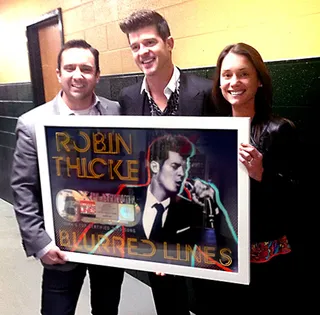 February 27, 2014 – Platinum Status&nbsp; - The true measure of a hit record is when supporters show up in numbers to purchase it. Thicke saw what this meant in action when the RIAA presented him with a platinum plaque for "Blurred Lines," which sold 6 million plus records.&nbsp;(Photo: Courtesy of RIAA)