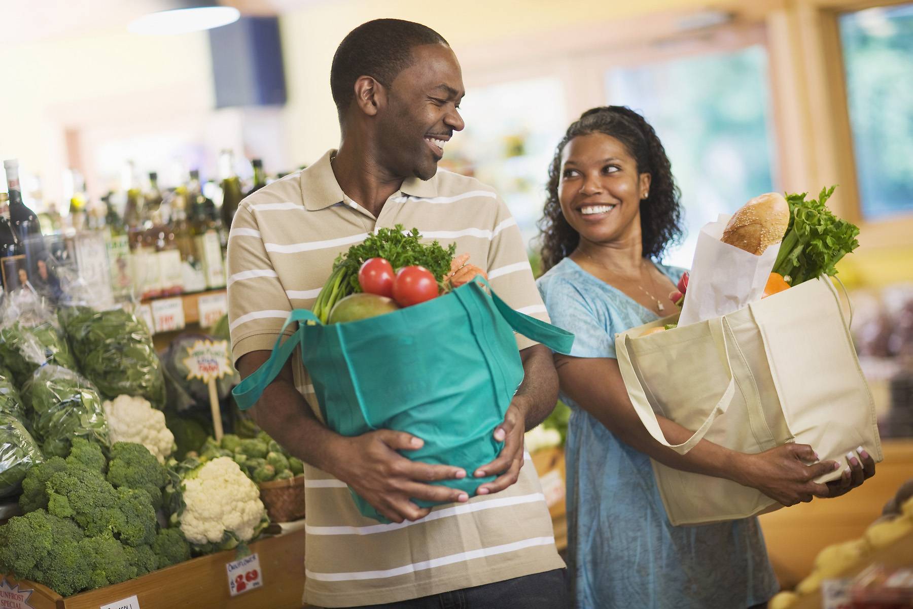 Pleasant person. Счастливая женщина с овощами. Man in shop. Black man shopping. Shop people.