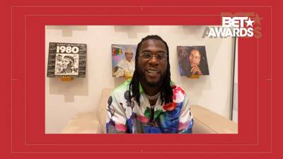 Burna Boy - Burna Boy showed up in viewers' living rooms rocking a very colorful and bright shirt as he accepted the 2020 BET award for Best International Artist. He sported Versace shades and wore a gold chain around his neck.&nbsp; (Photo: BET)
