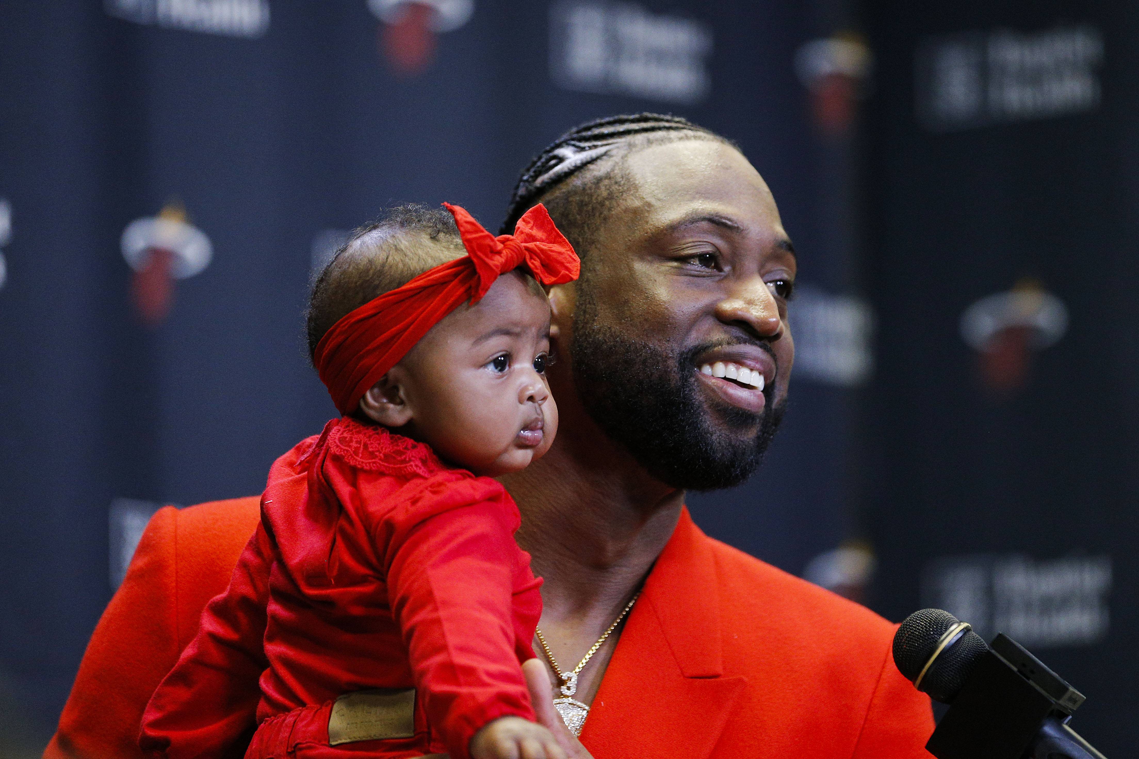 MIAMI, FLORIDA - APRIL 09: Dwyane Wade #3 of the Miami Heat addresses the media after his final regular season home game at American Airlines Arena with his daughter, Kaavia James Union Wade, on April 09, 2019 in Miami, Florida. NOTE TO USER: User expressly acknowledges and agrees that, by downloading and or using this photograph, User is consenting to the terms and conditions of the Getty Images License Agreement.  (Photo by Michael Reaves/Getty Images)