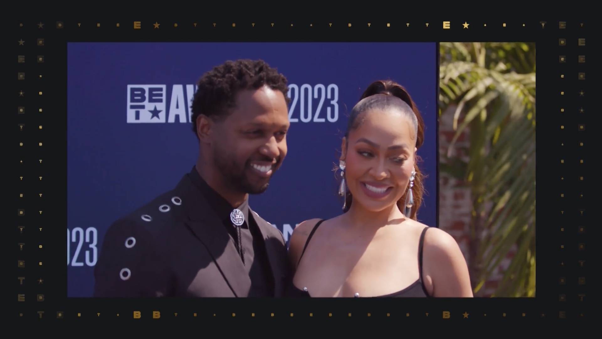 La La Anthony and her guest in black outfits on the BET Awards 2023 red carpet.