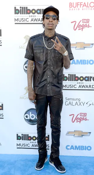 Wiz Khalifa - Chucking up his deuces, Wiz dresses in head-to-toe all-leather everything, but it’s his utility shirt loaded with buttons, pockets and zippers that makes his look standout.   (Photo: Jeff Bottari/Getty Images)
