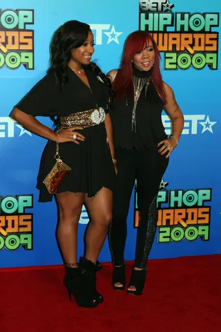 Red Carpet Style - Toya prowls the red carpet with her best bud Tiny at the BET Hip Hop Awards. She keeps it casual with leather ankle booties and a black symmetrical hem dress with a gold designer belt. (Photo: Getty Images)