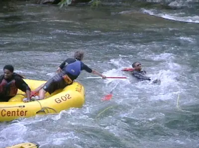 Man Overboard! - Dorion falls out of the raft, and he drags Dennis along with him.