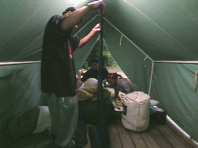 New Home - Anthony and Dennis get settled into their tent. Comfy?