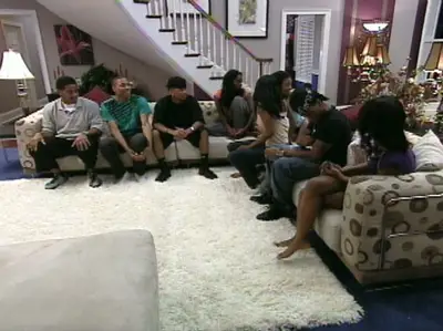 House Meeting - The gang meets in the living room and waits for a surprise to arrive.