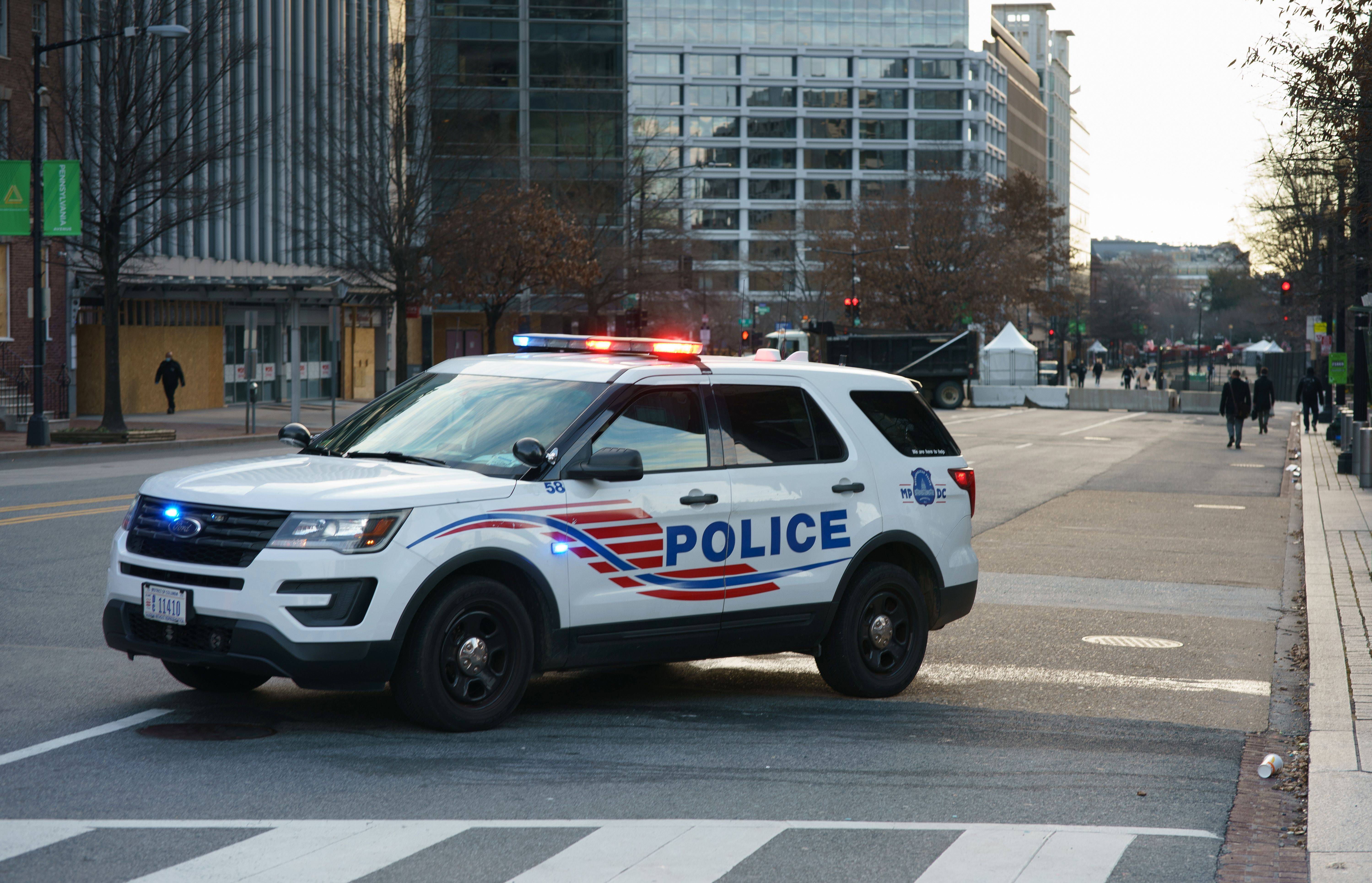 A DC police car blocks Pennsylvania Avenue leading to the White House in Washington, DC on January 19, 2021. - President Donald Trump began his final full day in the White House on January 19, 2021 with a long list of possible pardons to dish out before snubbing his successor Joe Biden's inauguration and leaving for Florida. On January 20, 2021 at noon, Biden will be sworn in and the Trump presidency will end, turning the page on some of the most disruptive, divisive years the United States has seen since the 1960s. (Photo by MANDEL NGAN / AFP) (Photo by MANDEL NGAN/AFP via Getty Images)