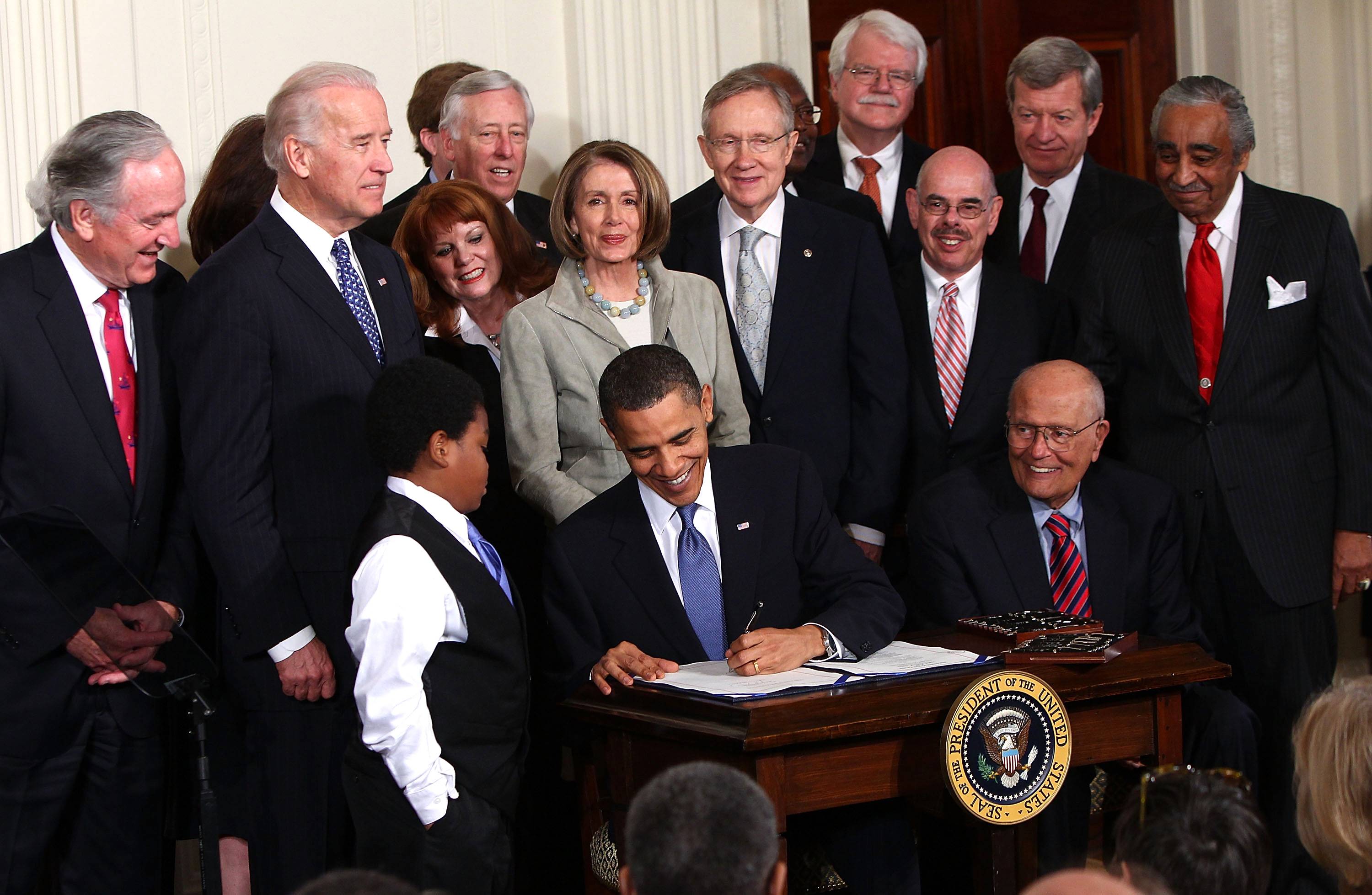 Barack Obama Signs Affordable Care Act