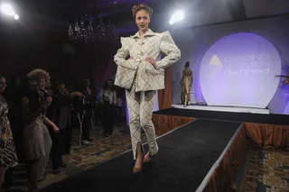 Funky Shapes&nbsp; - A model wears a structured suit with gold hardware accents.   (Photo: Brad Barket/PictureGroup)